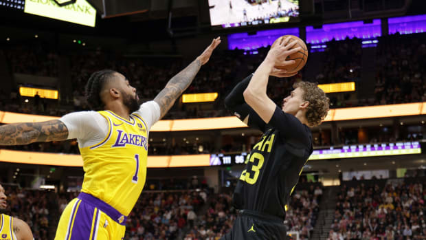 Feb 14, 2024; Salt Lake City, Utah, USA; Utah Jazz forward Lauri Markkanen (23) shoots the ball past Los Angeles Lakers guard D'Angelo Russell (1) during the second half at Delta Center. 